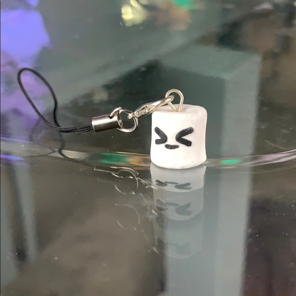 A handmade marshmallow clay charm